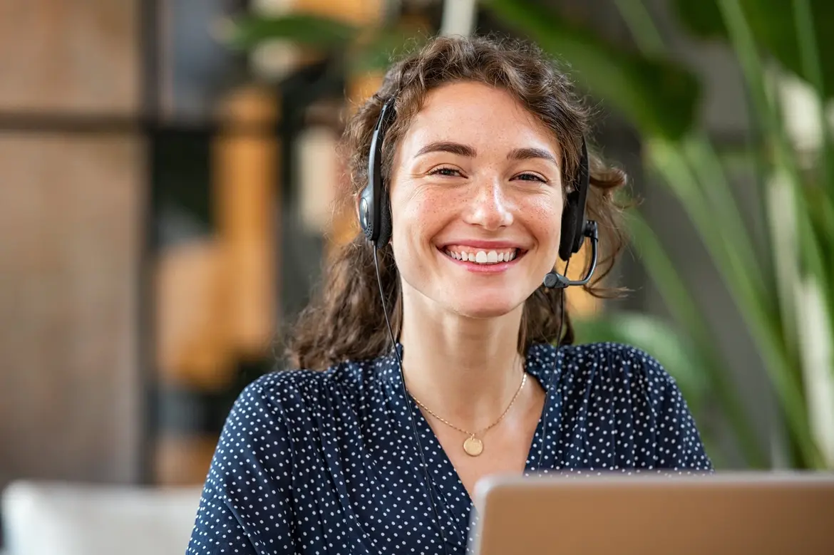 Woman wearing headset, smiling